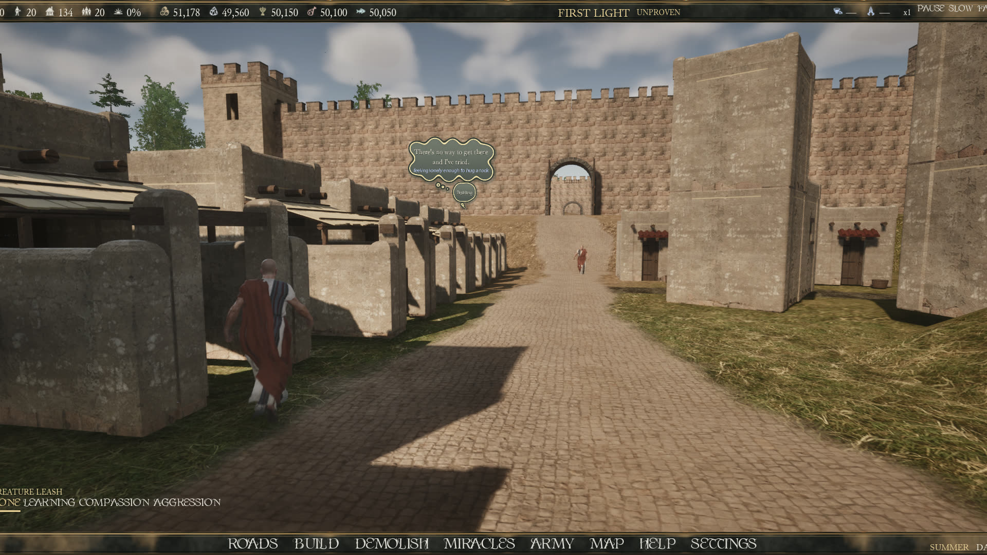 A paved Roman street inside a walled settlement, with an arched gate at the end and shops along both sides